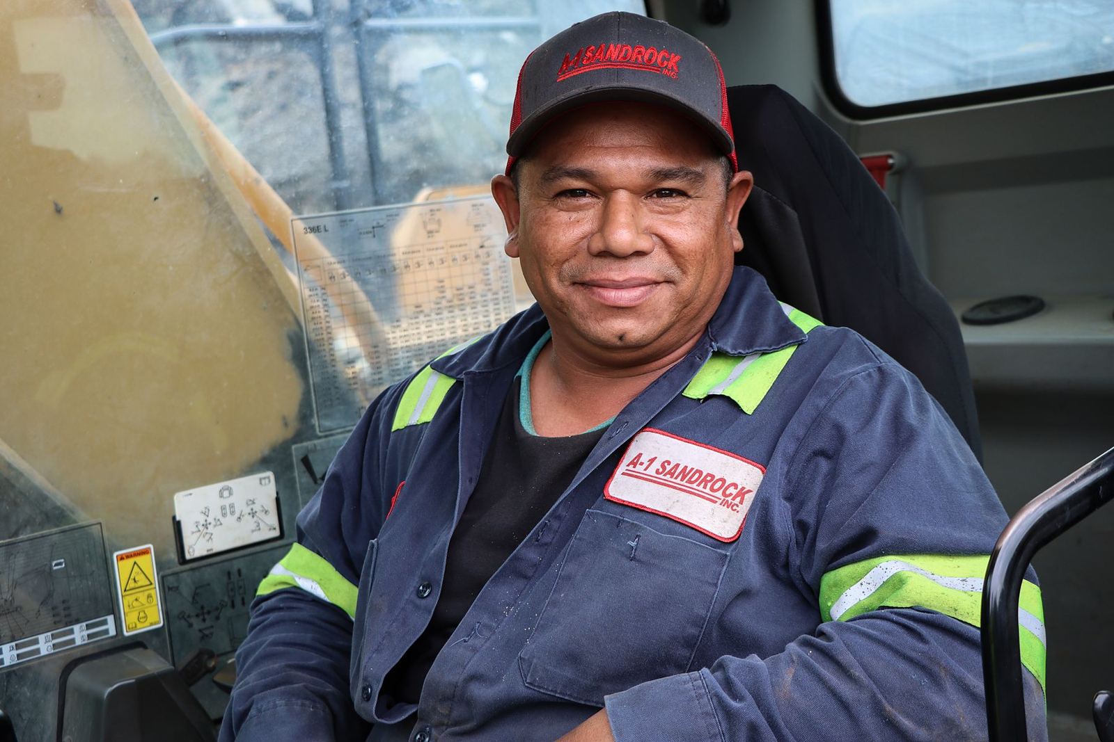 Arturo, an A-1 team member since 2010, in the cab of his excavator