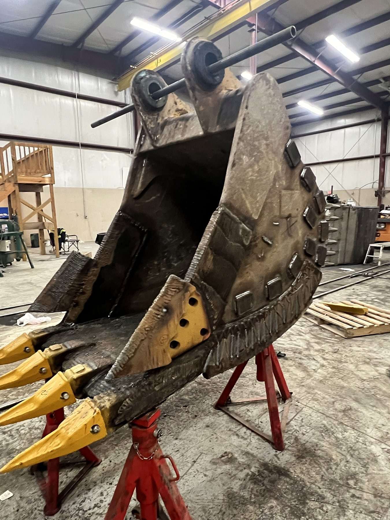 Rebuilt excavator bucket with new teeth and wear plates in the A-1 shop