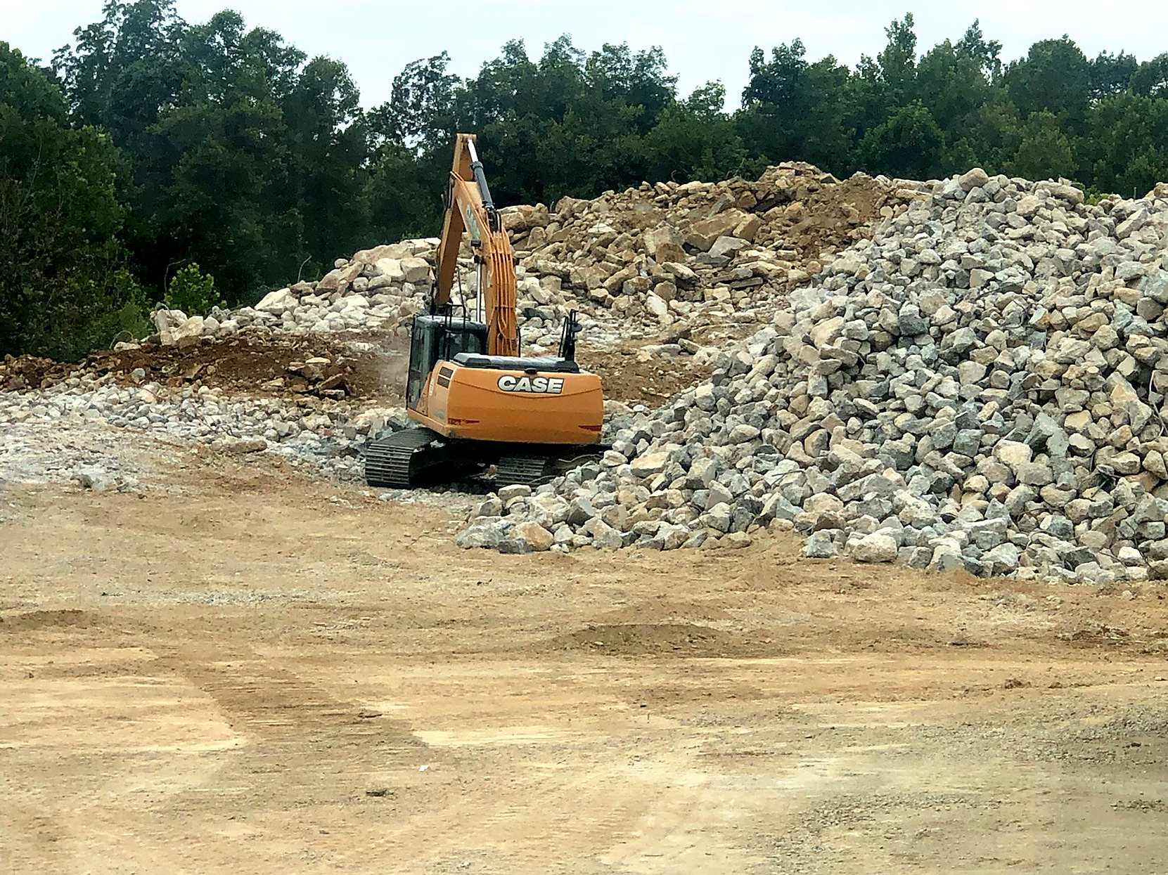 A-1 excavator sorting incoming broken concrete at the recycling yard