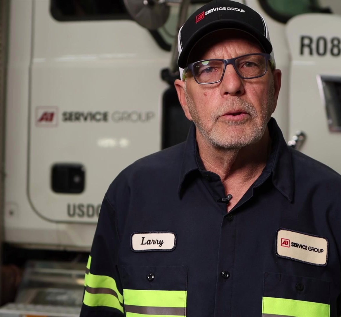 Larry Therrell, A-1 roll-off driver since 1994, in front of his truck