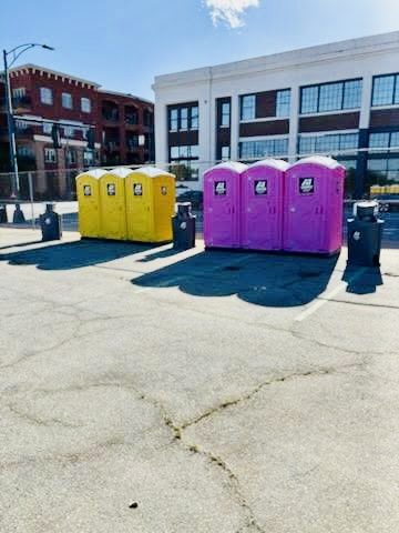 Yellow and purple A-1 portable toilets at a downtown event