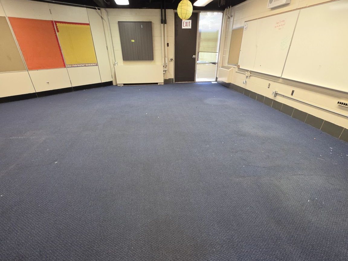 Classroom with carpet over old floor tile before asbestos abatement