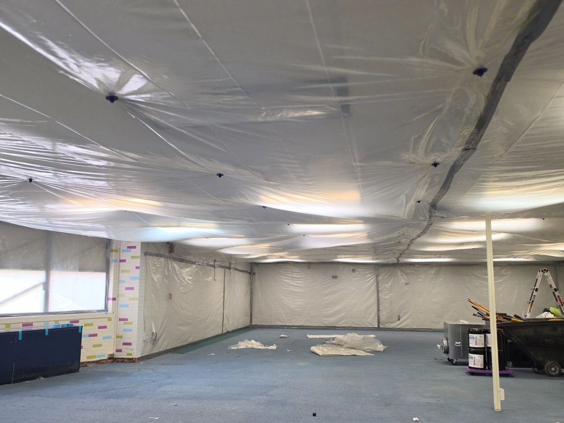 Classroom sealed floor to ceiling in plastic sheeting for asbestos abatement