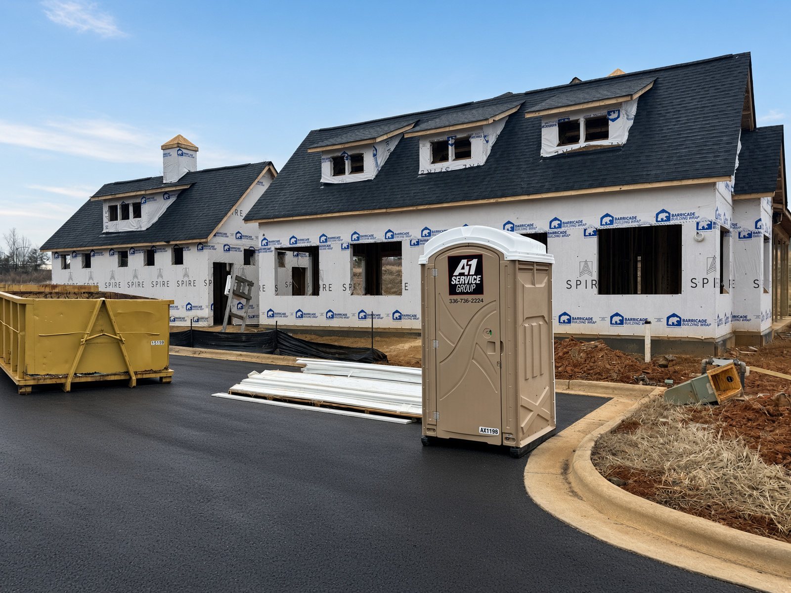 An A-1 roll-off dumpster and portable toilet at new homes under construction off Bonner Bridge Road in Burlington, NC