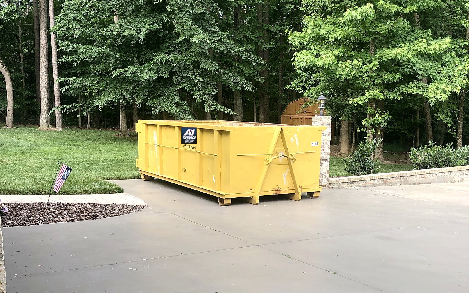 A 15 yard roll-off dumpster set on a home driveway