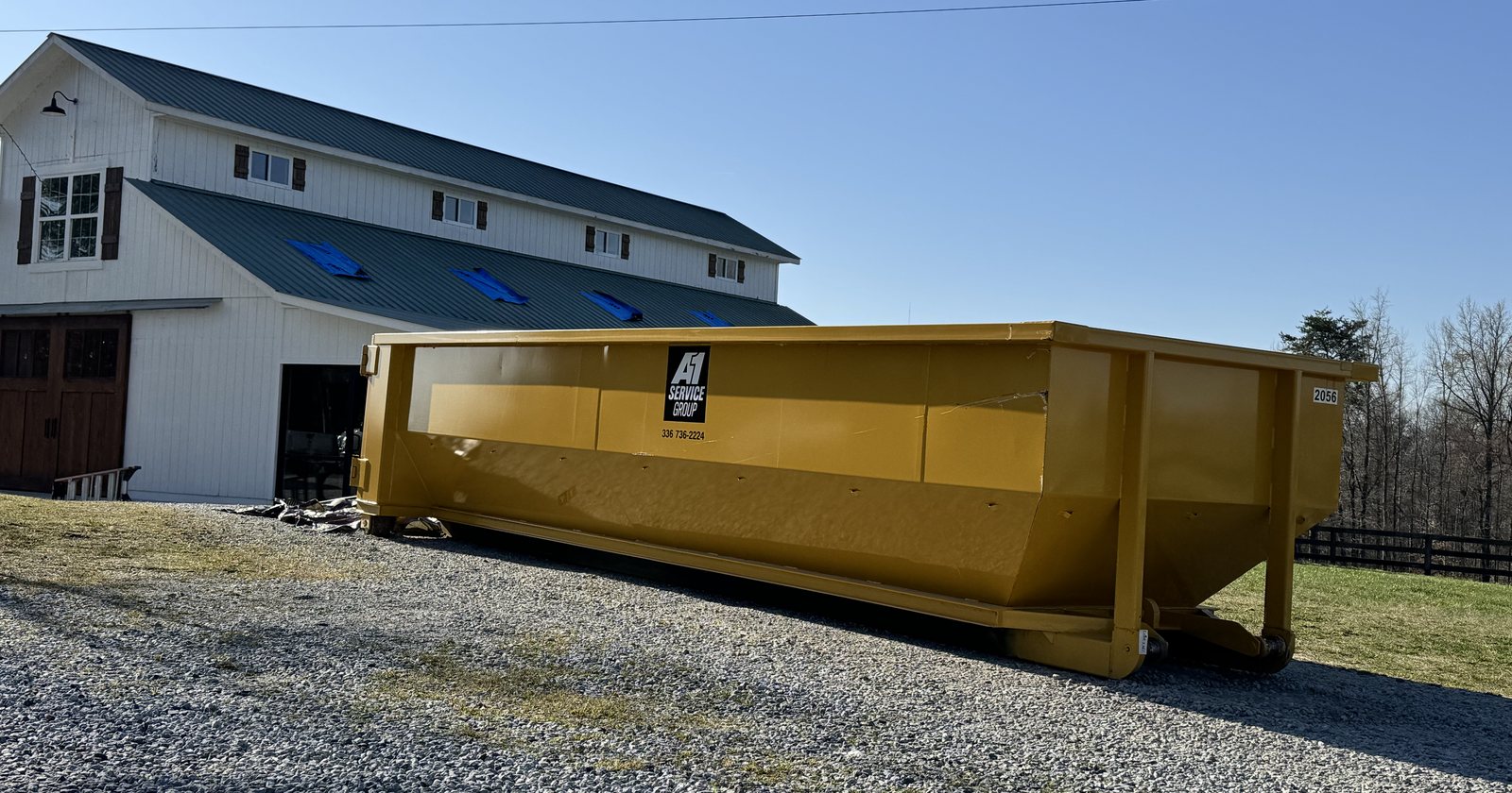 An A-1 roll-off dumpster at a barn renovation in Greensboro, NC