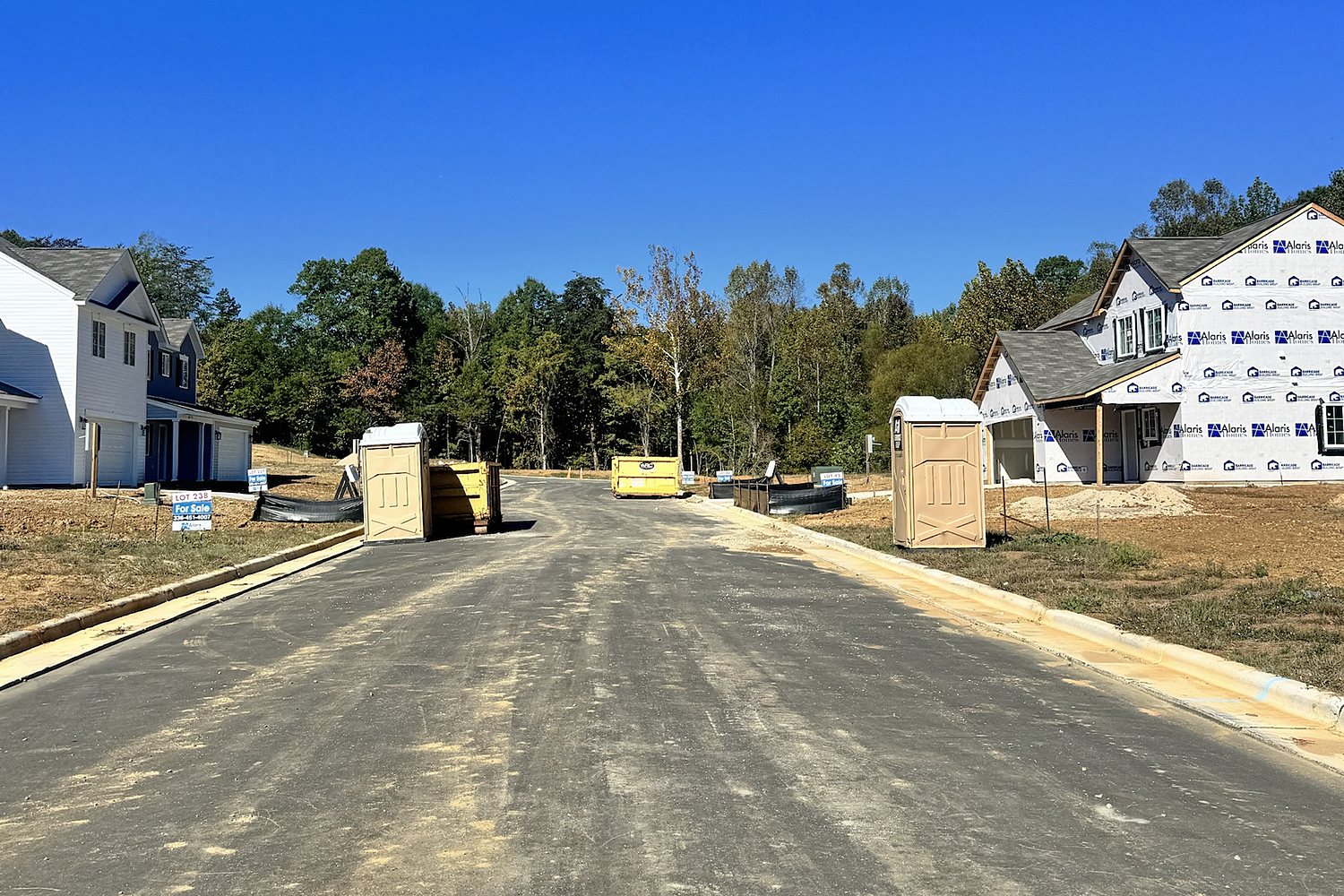 A-1 portable toilets and dumpsters lining a new street in the Thornton community, Greensboro