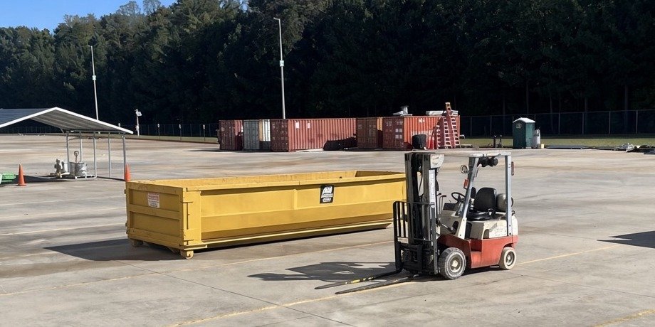 An A-1 roll-off dumpster in an industrial yard in Kernersville, NC