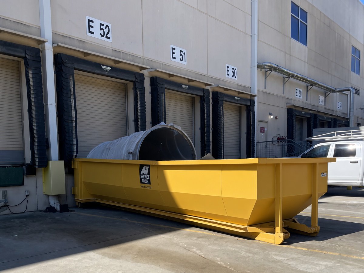 An A-1 roll-off dumpster at a manufacturing plant loading dock in Union Cross Business Park, Kernersville, NC
