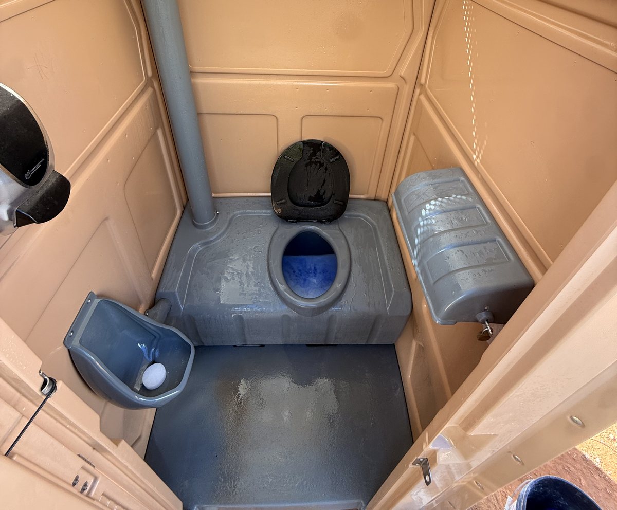 Clean A-1 portable toilet after service with fresh blue in the tank