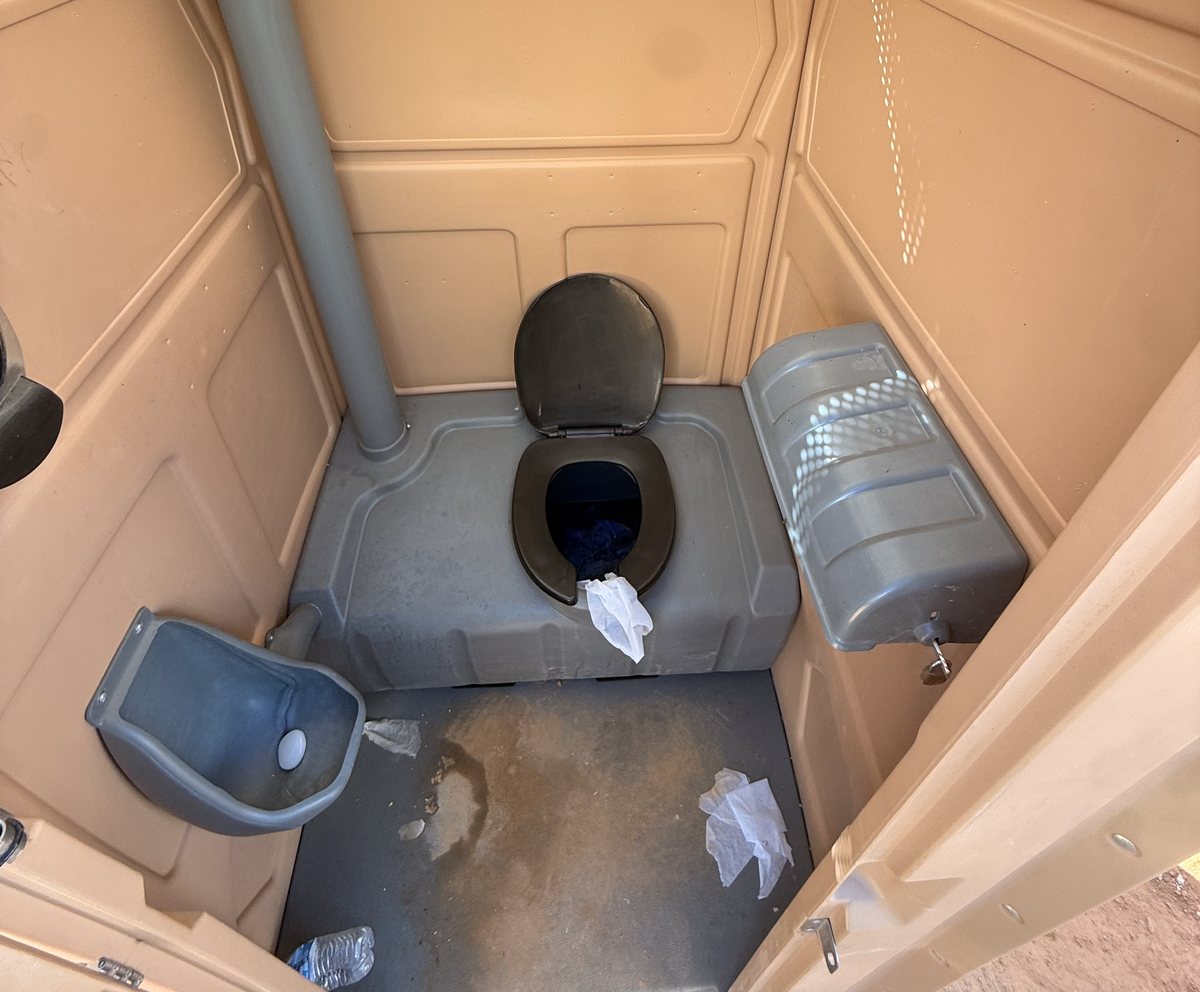Inside an A-1 portable toilet on a job site before service