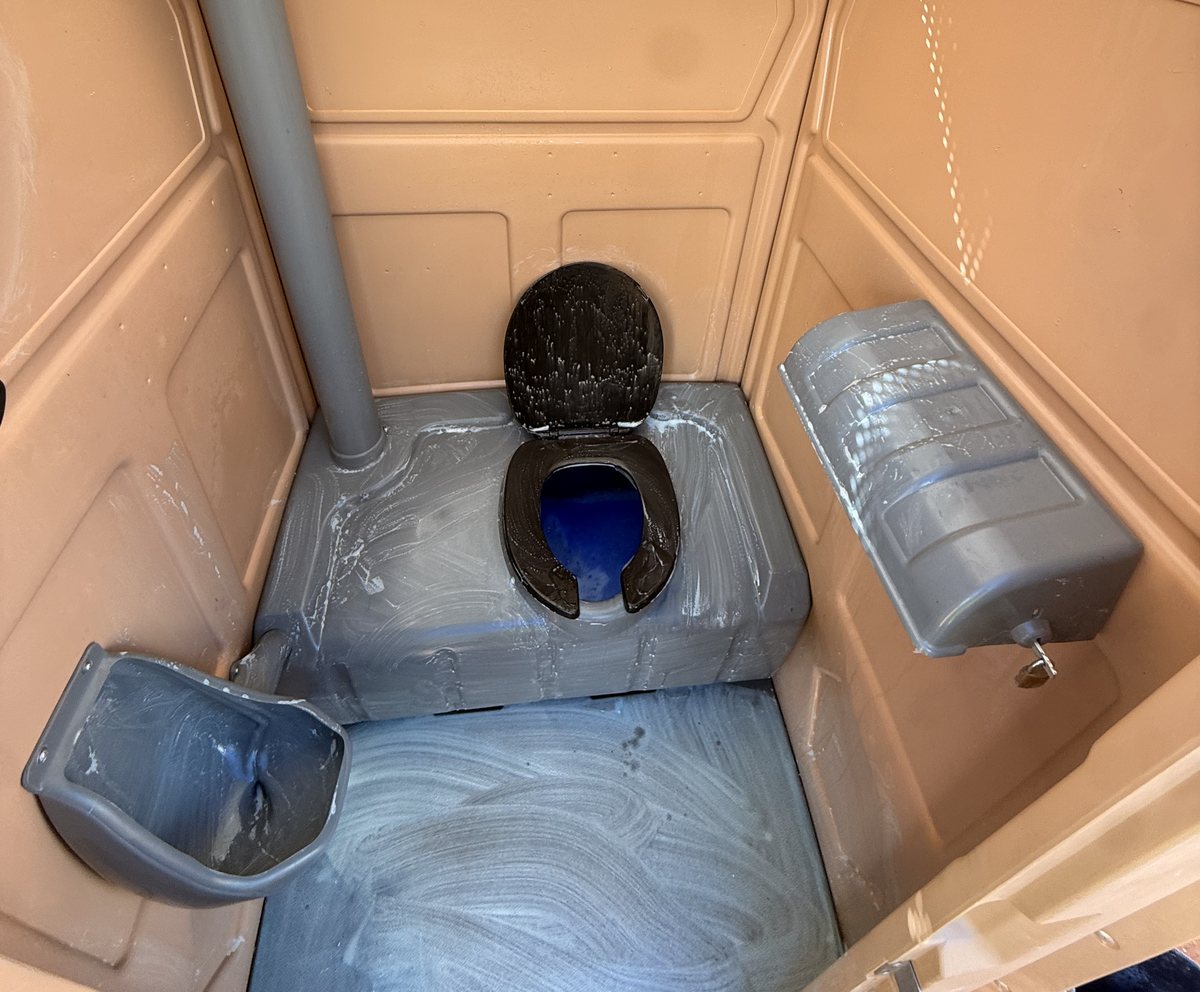 A-1 portable toilet being scrubbed down during service
