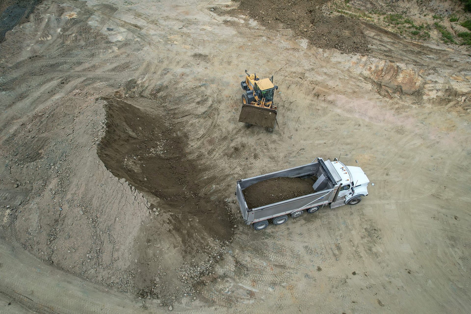 A-1 wheel loader and a customer dump truck at Viewmont Sandrock Pit, seen from above