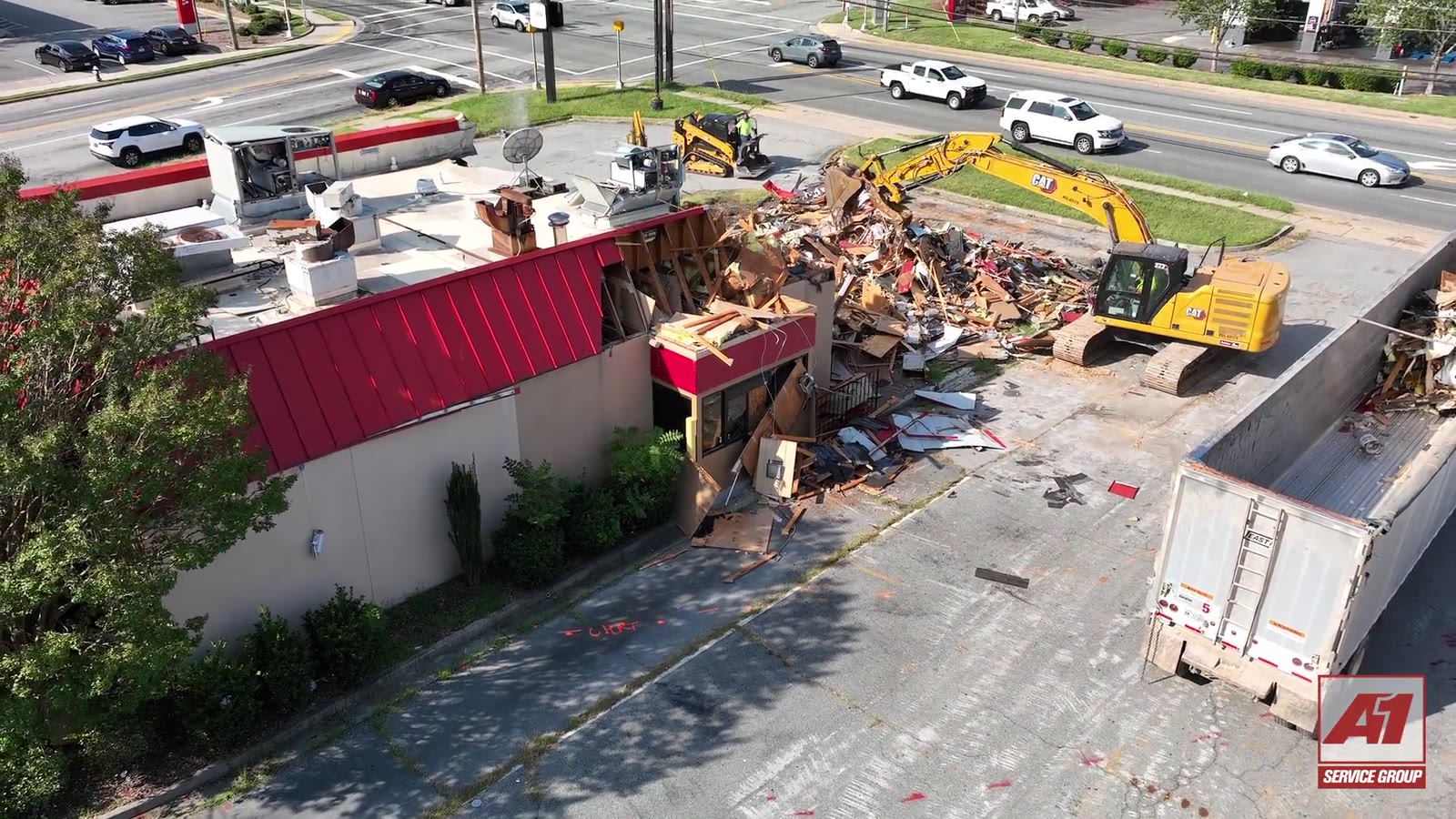Two A-1 excavators tearing down a former Hardee's in Greensboro, loading an A-1 trailer