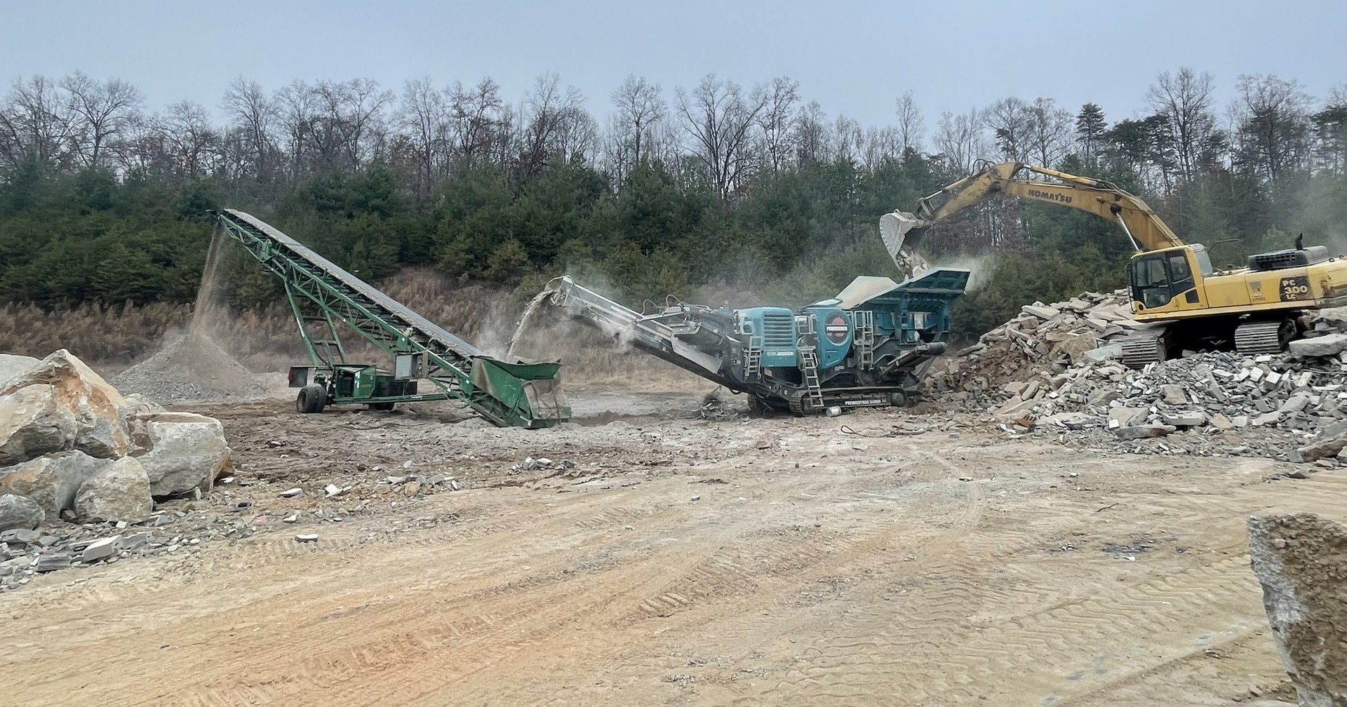 A-1 excavator feeding broken concrete into a crusher