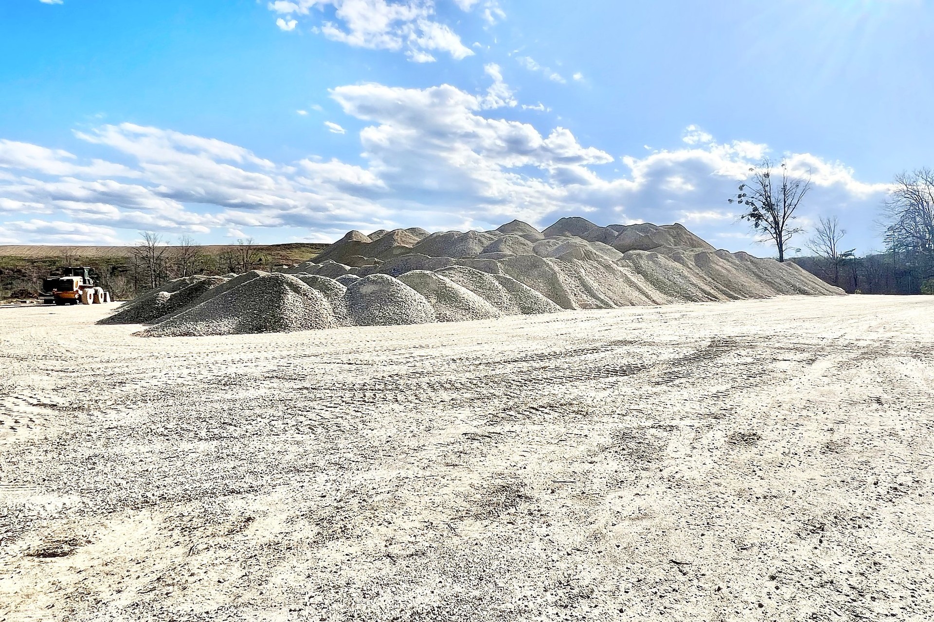 Stockpiles of recycled crushed concrete stone ready for pickup