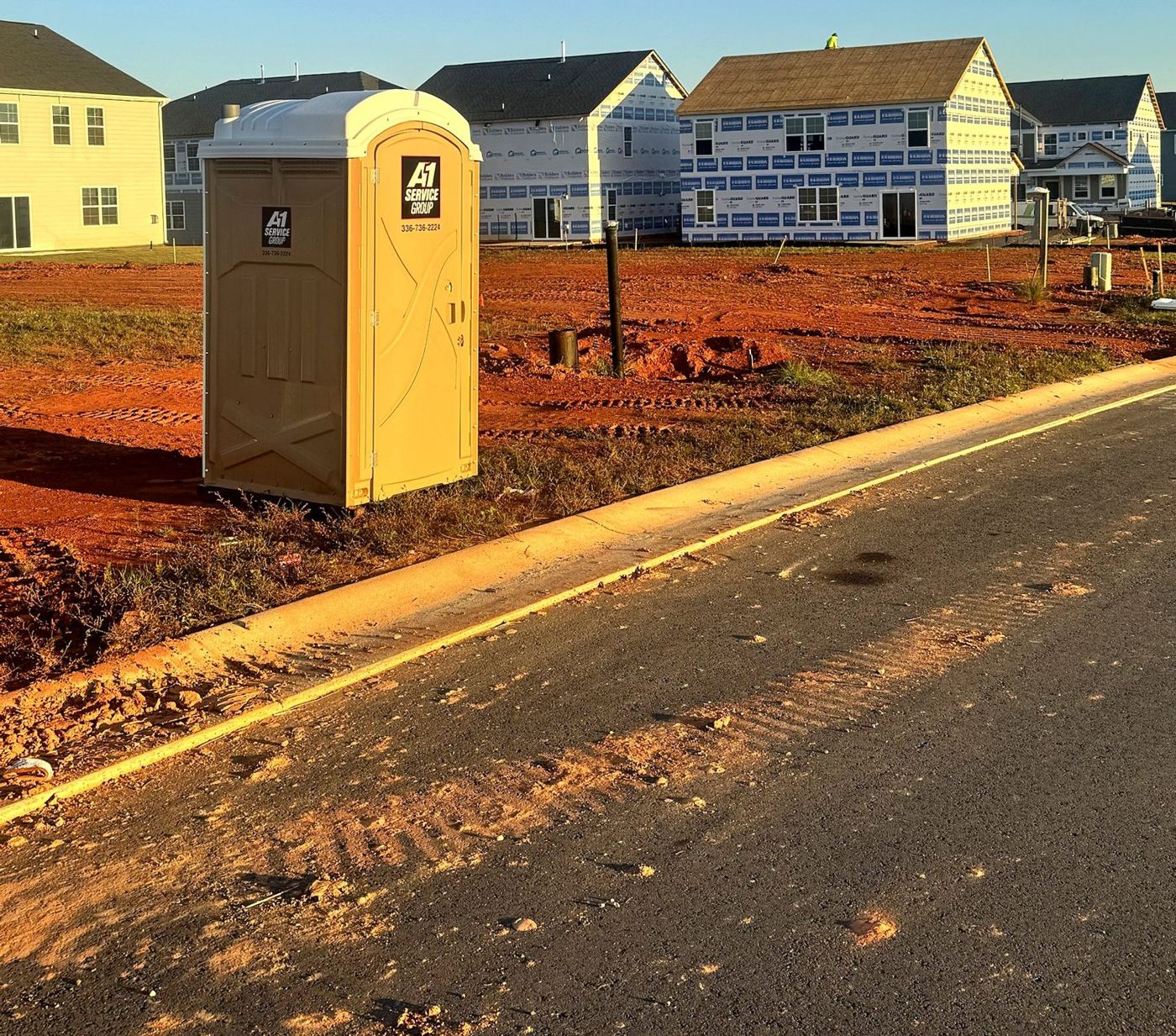 A-1 portable toilet beside new homes under construction in Kinsley, Jamestown, NC